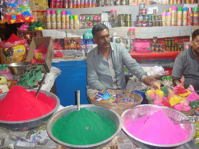 A shopkeeper selling holi colors